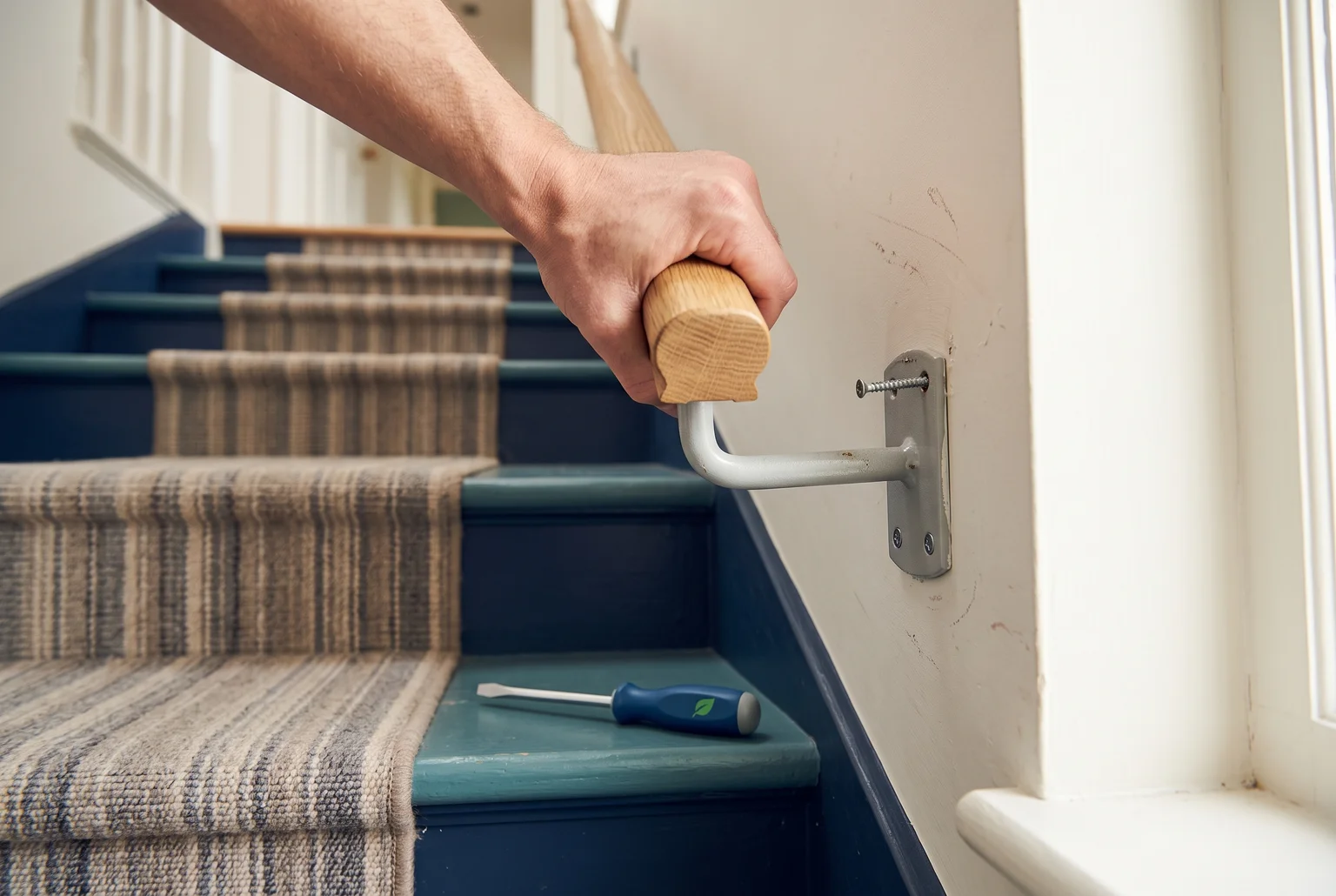 A quick wiggle test tells you whether your handrail just needs a screwdriver or needs a professional look at the wall anchor.